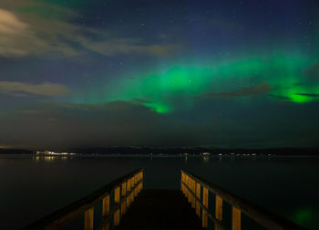 Scenic view of lake against sky at night