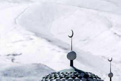 Close-up of chain hanging on snow covered land