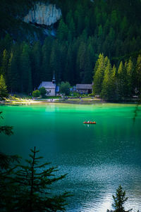 Scenic view of lake by trees against sky