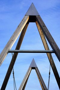 Low angle view of bridge against blue sky