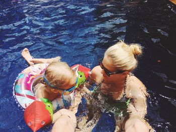 High angle view of family enjoying summer in swimming pool