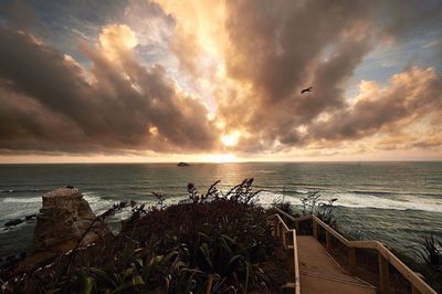 Scenic view of sea against cloudy sky