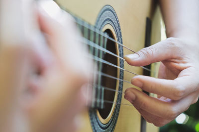 Cropped image of man playing guitar