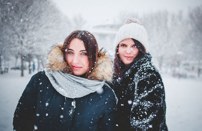 Portrait of smiling young woman in snow