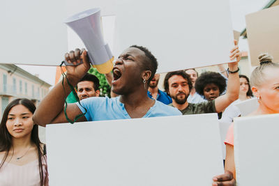 People protesting while standing on land