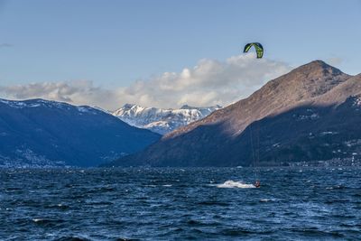 Scenic view of sea and mountains against sky