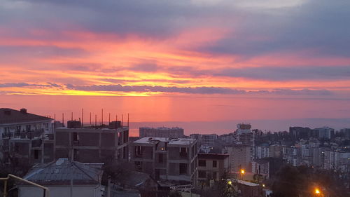 High angle view of buildings against sky during sunset