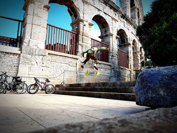 Bicycle by building in city