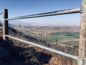 Scenic view of field seen through railing