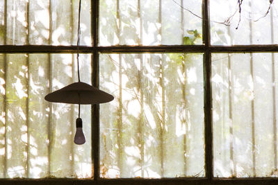 Old windows in old building and light equipment in factory, sunlight