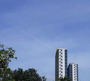 Low angle view of vapor trail against blue sky