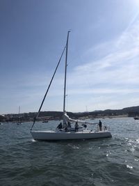 Sailboat sailing on sea against sky