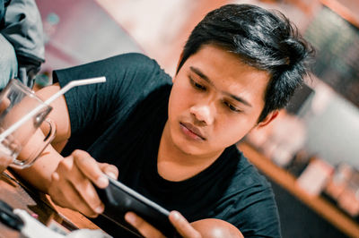 High angle portrait of man holding camera