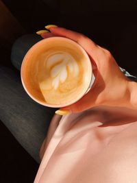 Woman holding coffee cup