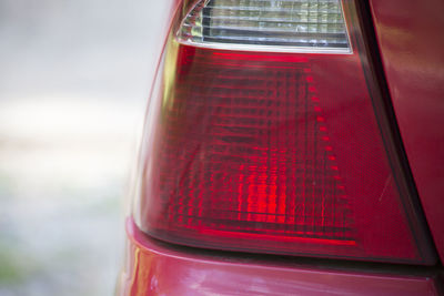 Close-up of red car on road