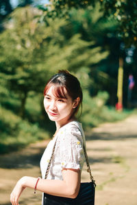 Portrait of young woman standing outdoors