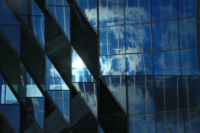 Low angle view of glass building against sky