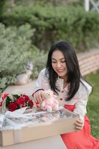 Portrait of young woman with bouquet