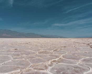 Scenic view of salt flat against sky