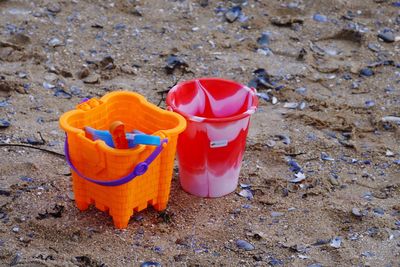 High angle view of buckets on sand at beach