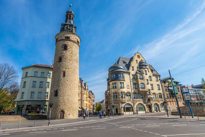 Street amidst buildings in city against sky