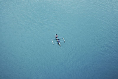 High angle view of man floating on sea