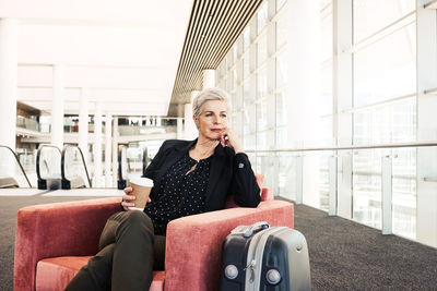 Portrait of young woman sitting in bus