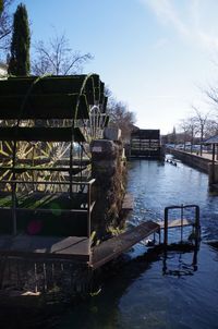 Gazebo by river against sky