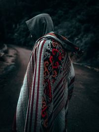 Rear view of man standing with umbrella