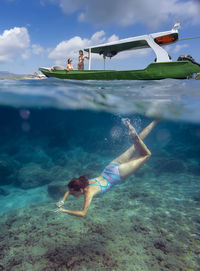 Young women have a fun in ocean, underwater view