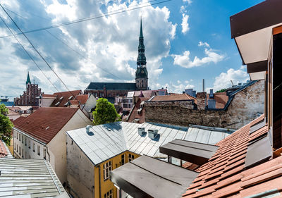 Buildings in city against cloudy sky