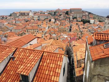 High angle view of houses in town against sky