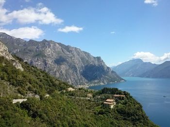 View of calm beach against mountain range