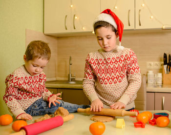 Smiling boys bake homemade festive gingerbreads. christmas cookies