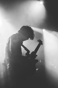 Man playing guitar at music concert