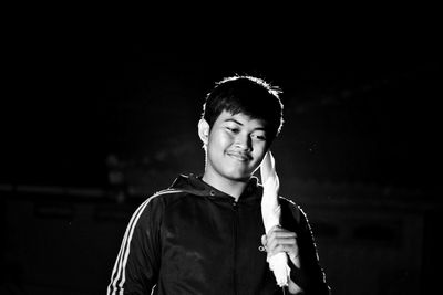 Portrait of a smiling young man standing outdoors