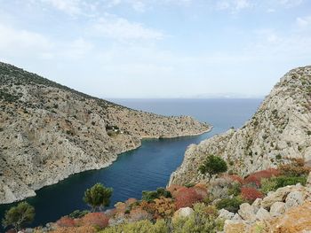 High angle view of sea and mountains against sky