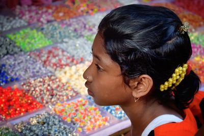 Close-up of woman with multi colored flowers