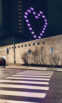 Zebra crossing on road in city at night