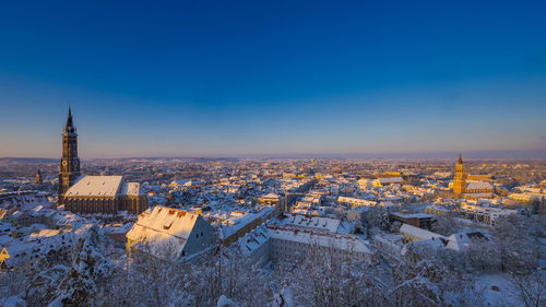 High angle view of cityscape against clear blue sky