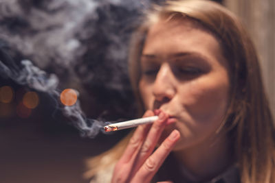 Close-up of woman smoking cigarette