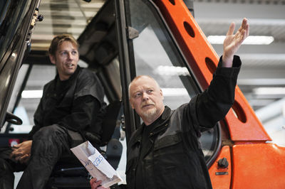 Two men talking in warehouse