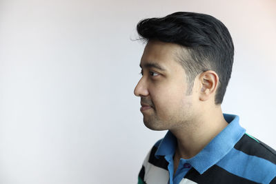 Portrait of young man against white background