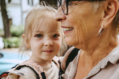 Portrait of cute girl with grandmother in city