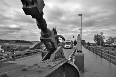 Cars on bridge against sky