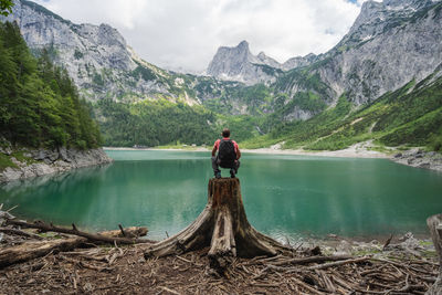 Man looking at lake against mountains