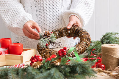 Midsection of woman holding christmas tree