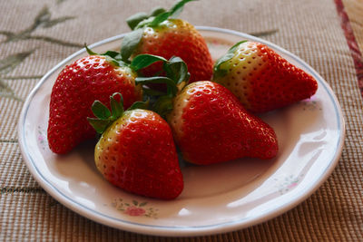 High angle view of strawberries in plate on table