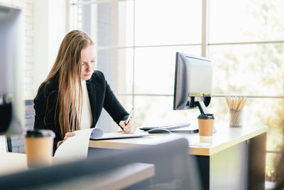 Woman using smart phone on table