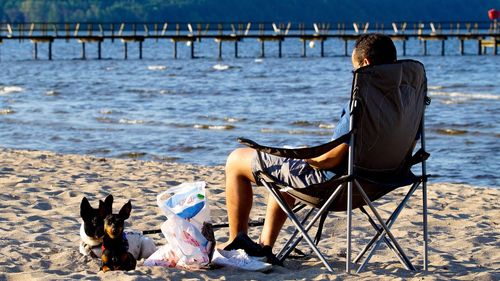 Two people sitting on pier